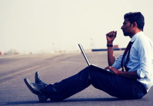 A blogger blogging with his laptop