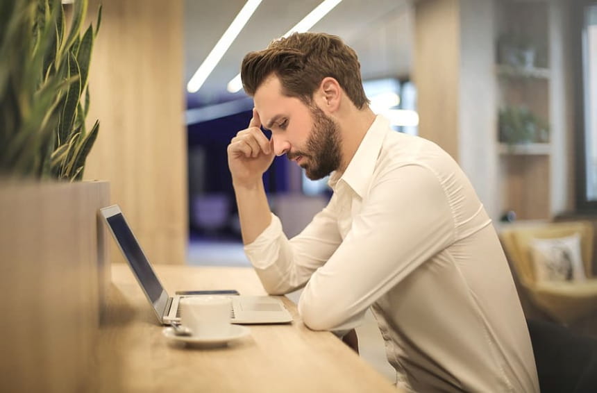 blogger sitting in front of laptop thinking on what type of blog make the most money