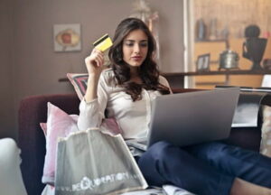 a woman blog reader choosing an affiliate marketing products on laptop with a credit card in hand