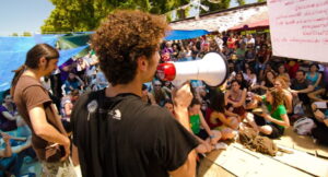 a male affiliate marketer is using a loudspeaker to promote affiliate marketing to his audience