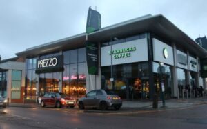 prezzo and starbucks coffee have chosen a nice location for their outlet with big name signboard