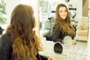 woman looking at her self in the mirror thinking about how to add personality to her writing