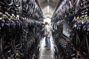 2 male engineers working on the database center of Google